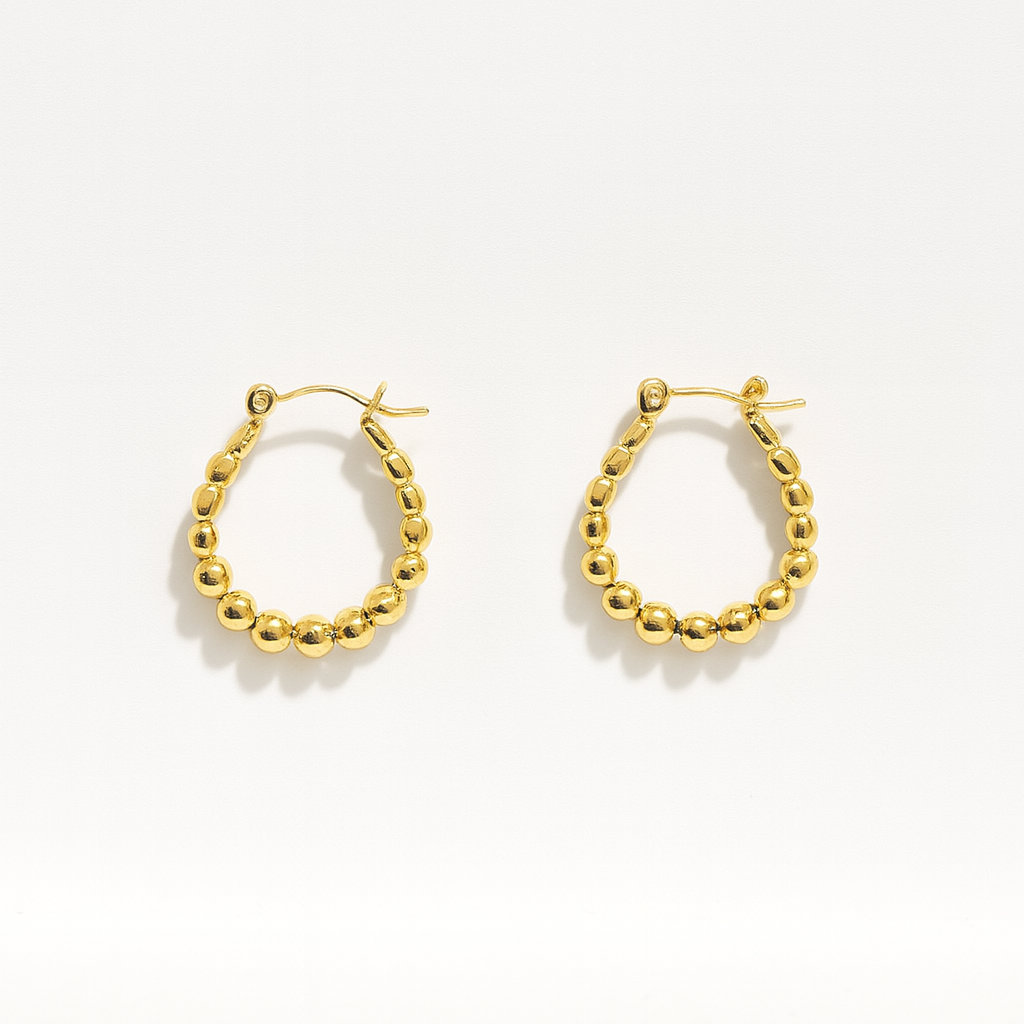Gold hoop earrings on a white background