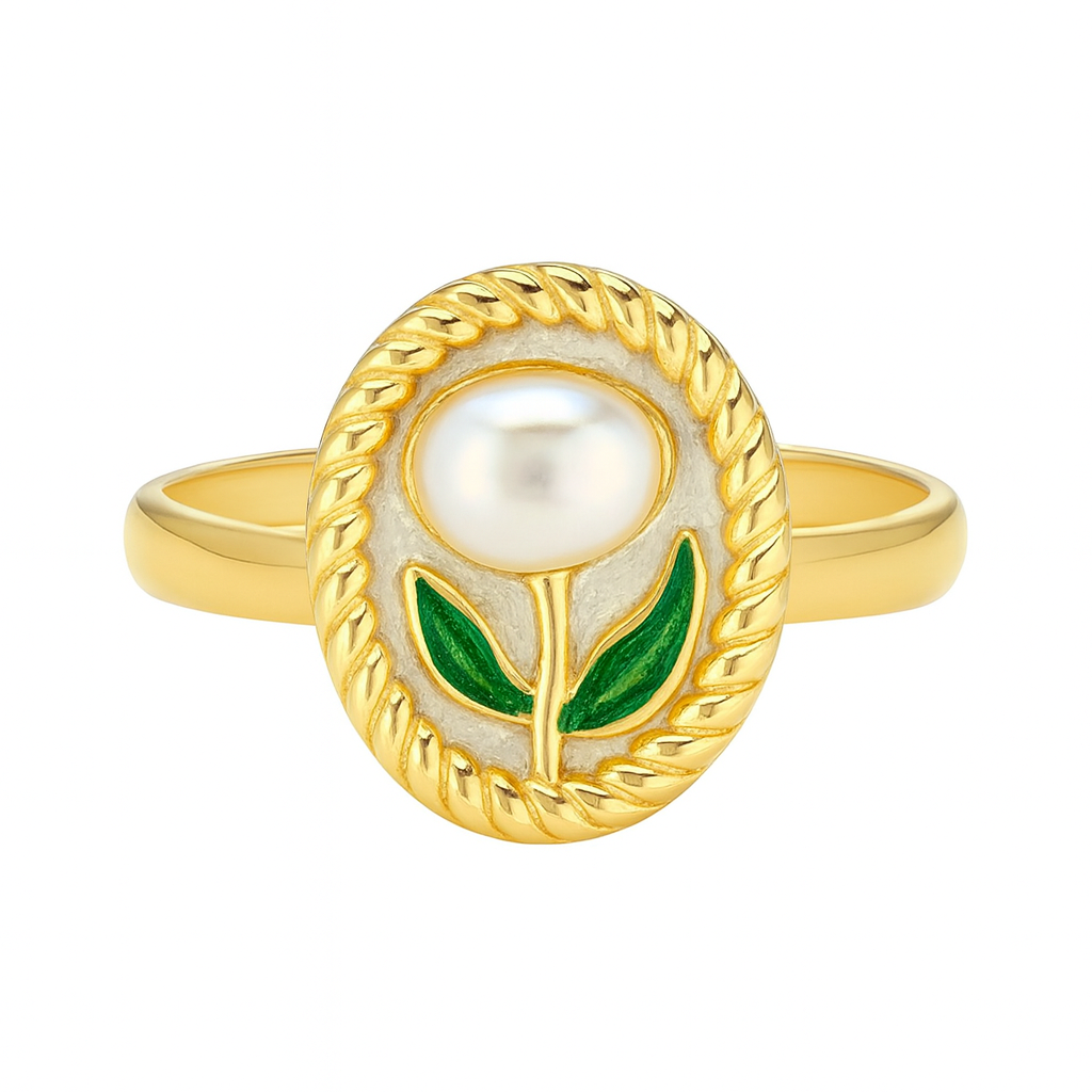 Gold ring with a pearl and green leaves on a white background