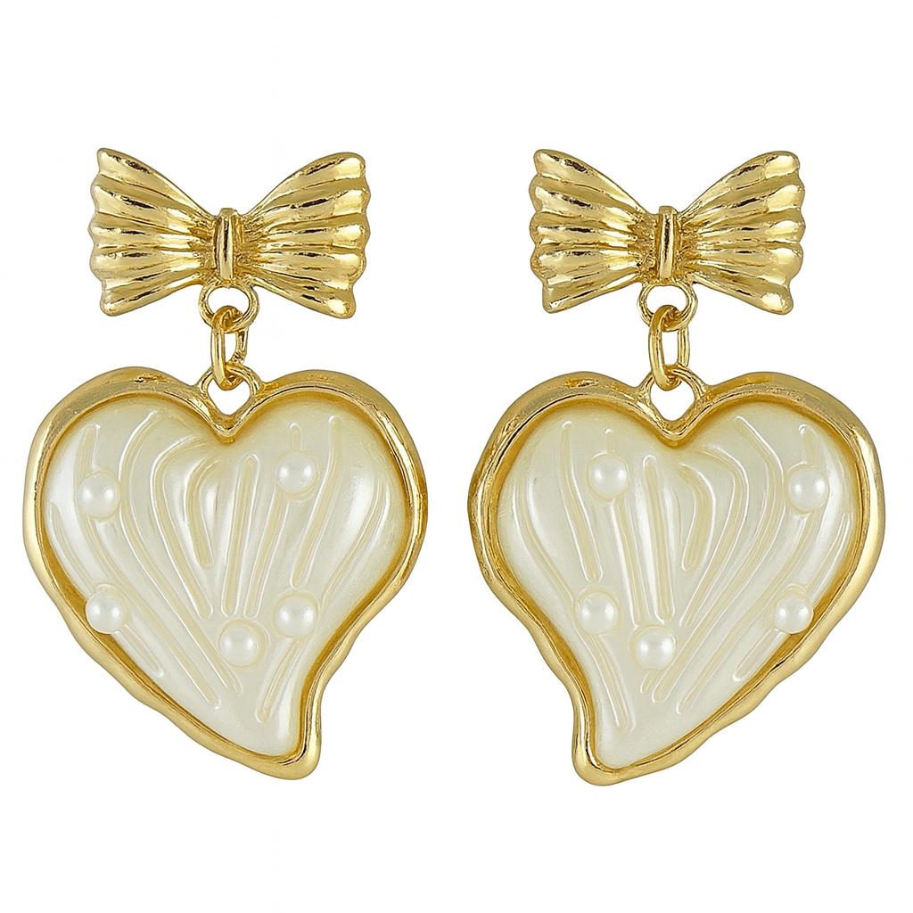 Pair of earrings with gold bows and heart-shaped white stones on a white background