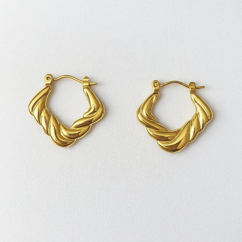 Pair of gold hoop earrings on a white background