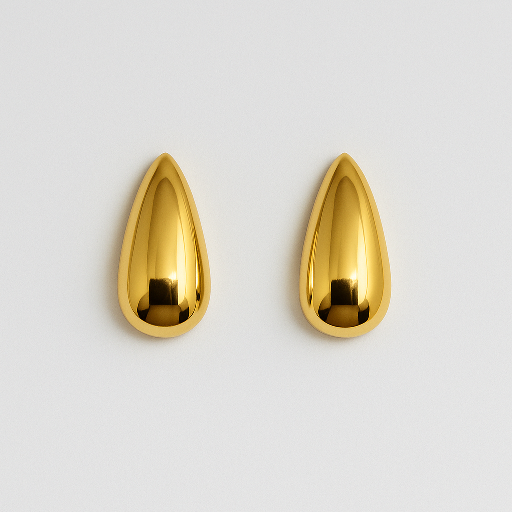 Pair of gold teardrop-shaped earrings on a light gray background