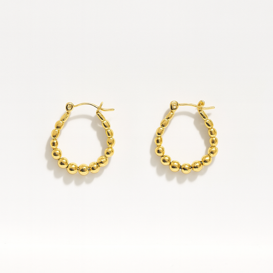 Gold hoop earrings on a white background

