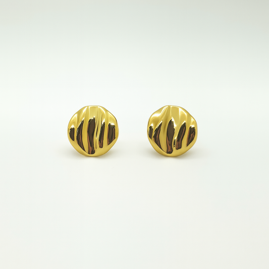 Pair of gold earrings with a textured design on a light gray background

