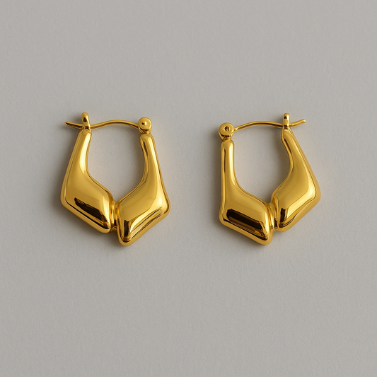 Pair of gold hoop earrings on a light gray background

