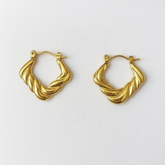 Pair of gold hoop earrings on a white background

