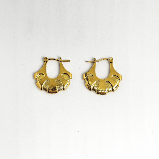 Pair of gold hoop earrings on a white background

