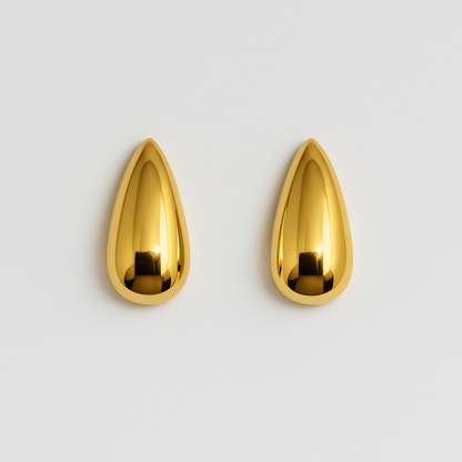 Pair of gold teardrop-shaped earrings on a light gray background

