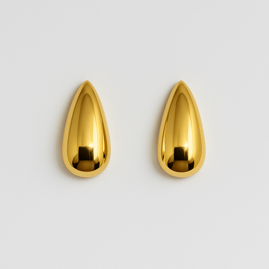 Pair of gold teardrop-shaped earrings on a light gray background


